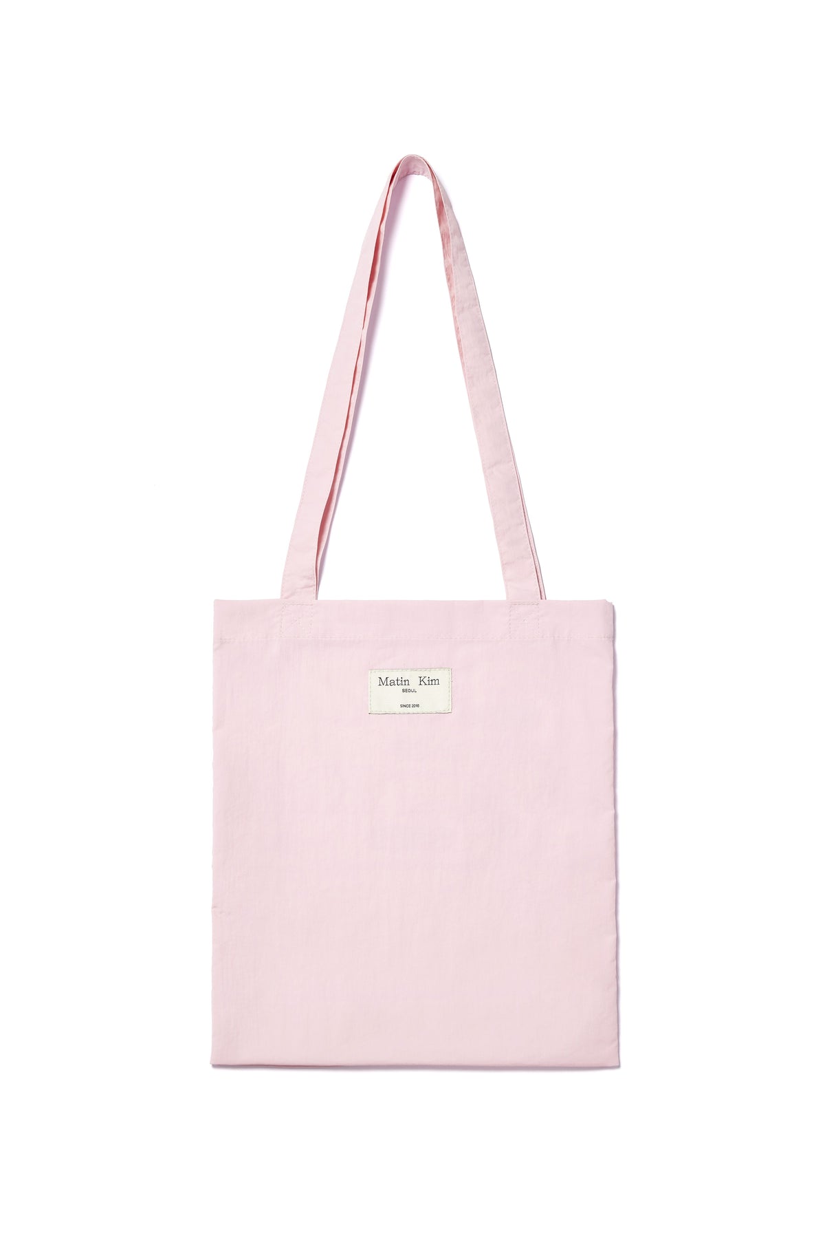 Túi tote unisex với họa tiết in và logo Matin Kim, màu hồng nổi bật.