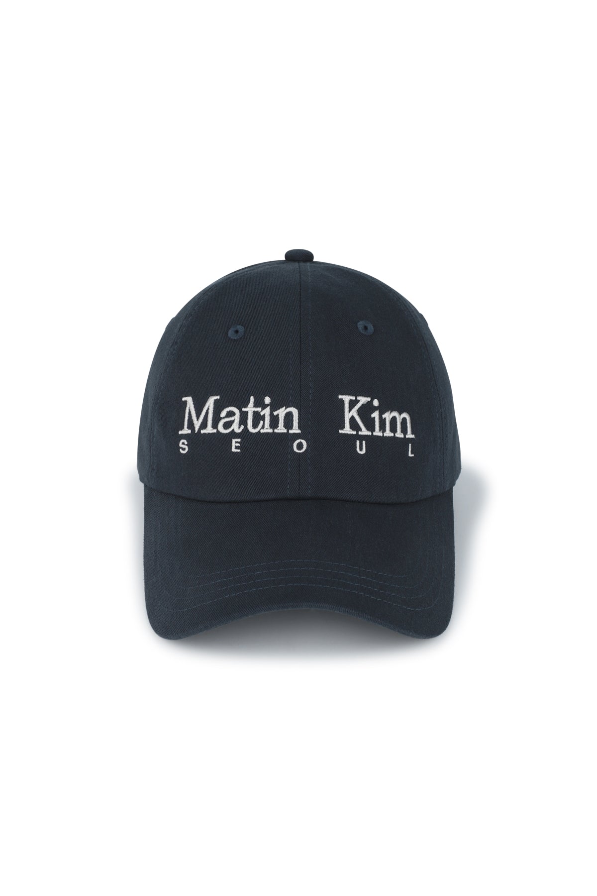 Mũ bóng chày unisex màu navy, vành cong, phom cứng, in logo Matin Kim ở mặt trước và dây strapback phía sau.