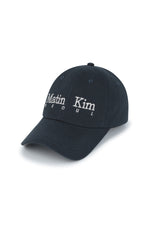 Mũ bóng chày unisex màu navy, vành cong, phom cứng, in logo Matin Kim ở mặt trước và dây strapback phía sau.