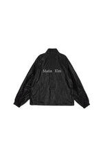 Áo khoác nữ oversize với logo Matin Kim, cổ áo thẳng, tay dài và thiết kế tinh tế.