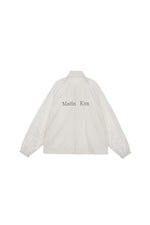 Áo khoác oversize nữ có cổ cao, tay dài, đường may rõ nét và logo Matin Kim.