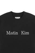 Áo unisex với thiết kế cổ tròn, tay ráp, và logo Matin Kim in lụa ngang ngực.
