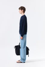 Áo len unisex với thiết kế thoáng khí, có túi trước và logo Matin Kim nổi bật.