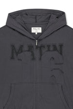 Áo khoác nữ với thiết kế hiện đại, logo Matin Kim thêu, chất liệu cotton mềm mại, và túi kangaroo tiện lợi.