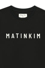 Áo top nữ với logo Matin Kim in nổi bật trên nền đen.