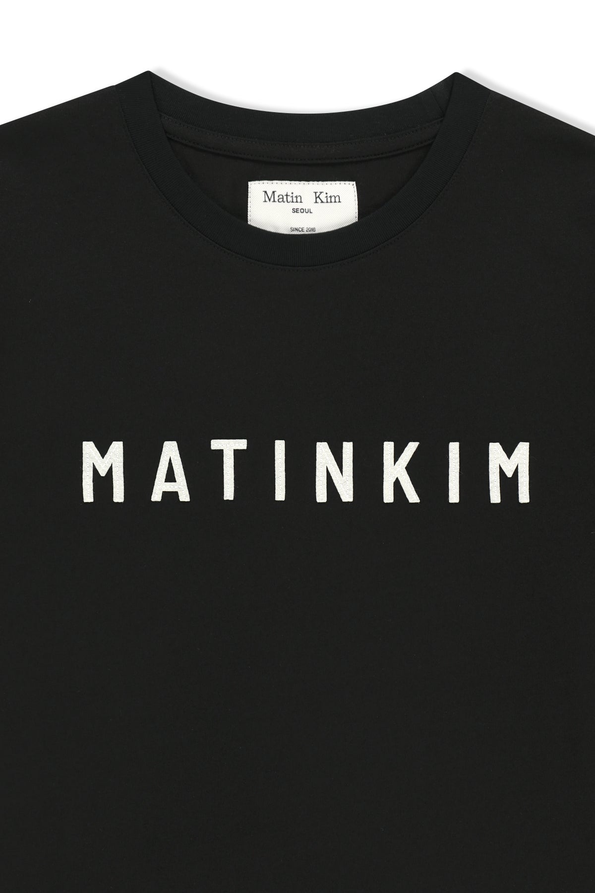 Áo top nữ với logo Matin Kim in nổi bật trên nền đen.
