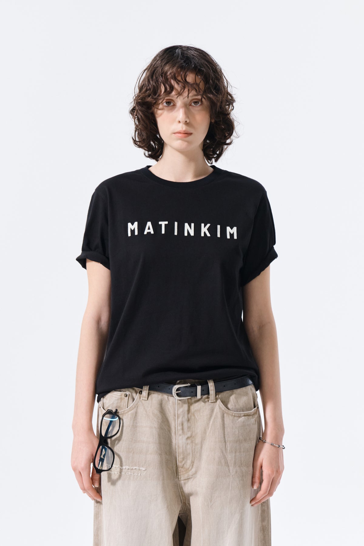 Áo top nữ với logo Matin Kim in nổi bật trên nền đen.