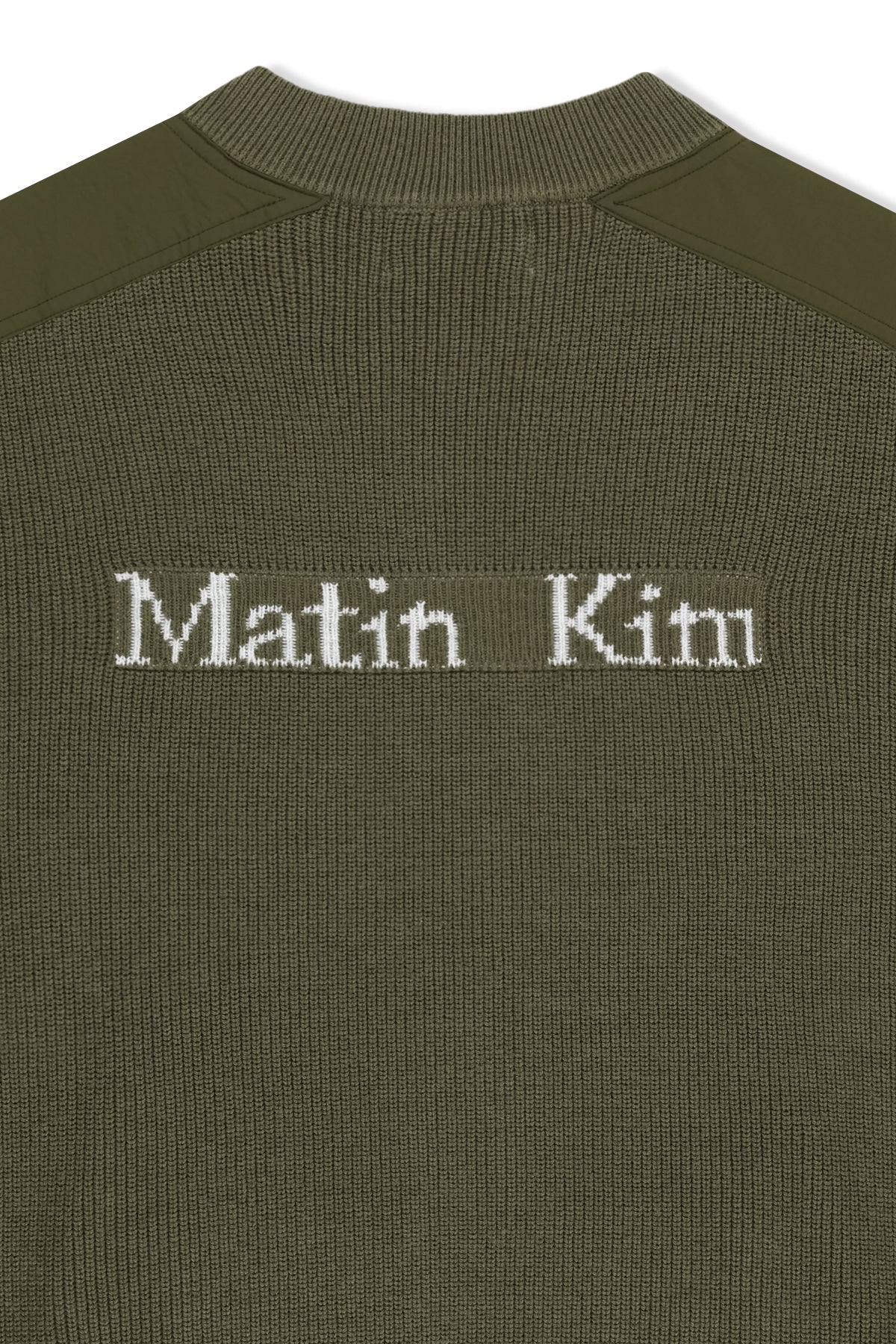 Áo sơ mi nam cotton màu khaki, tay dài, cổ tròn, có chữ ở lưng trên và hai túi hông.